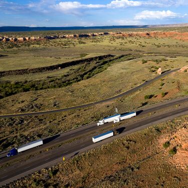 Cross Border Shipping from or To New Mexico Aerial view highway with semi trucks